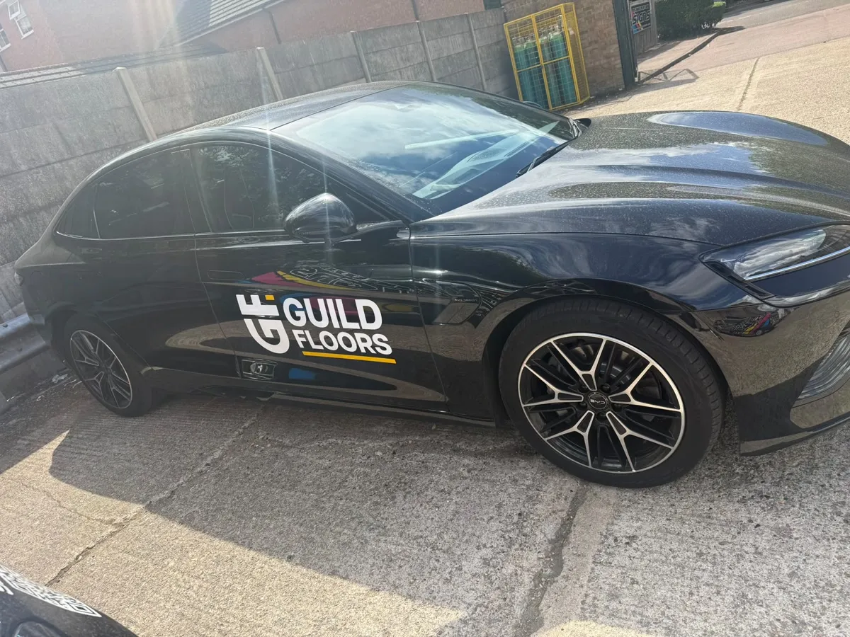 The Guild Floors mark applied to a company car